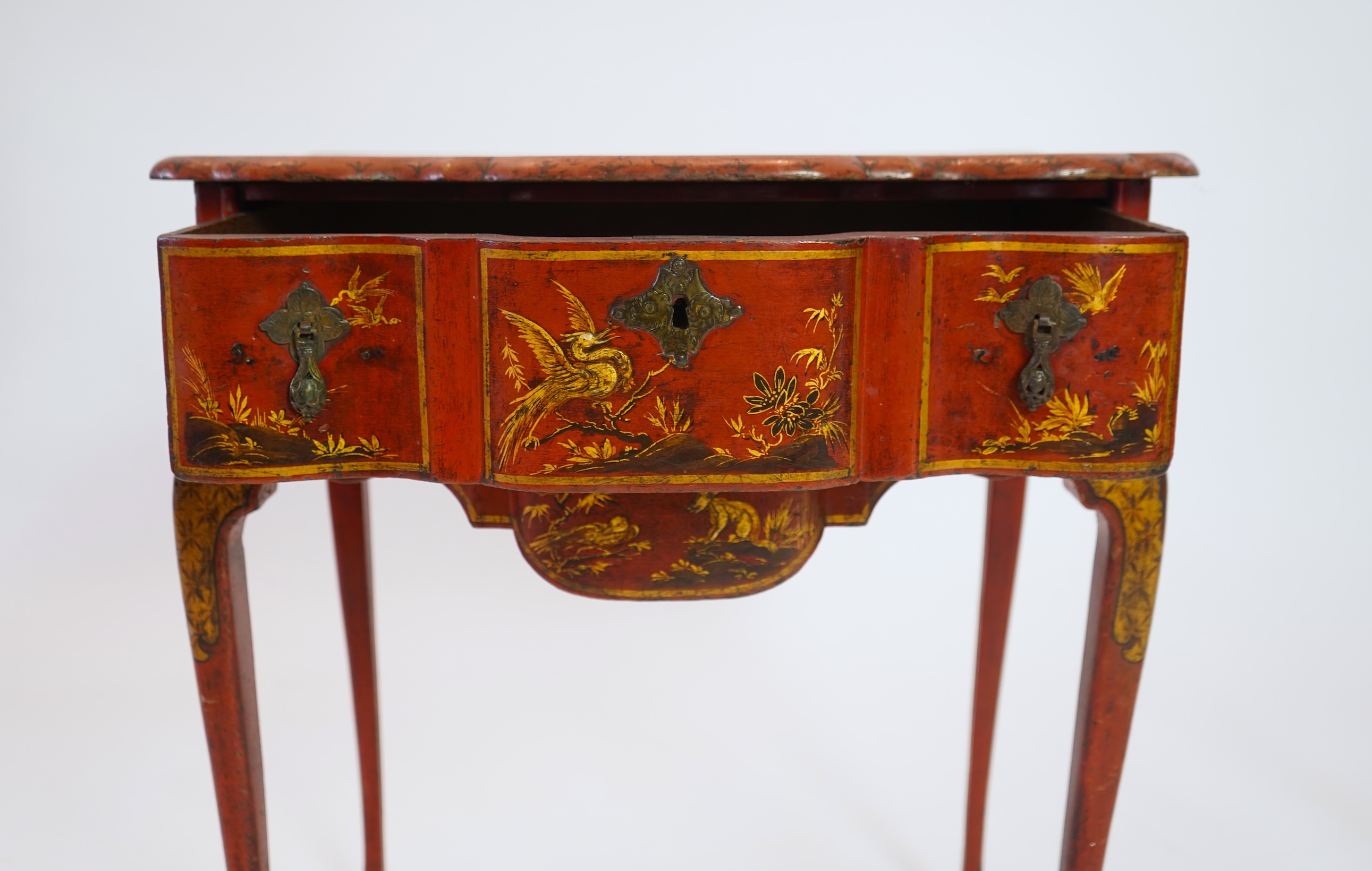 An early 18th century scarlet japanned lowboy